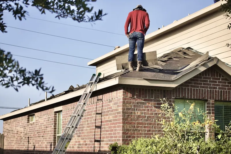Professional roofer working on a residential roof in Mcchord Afb